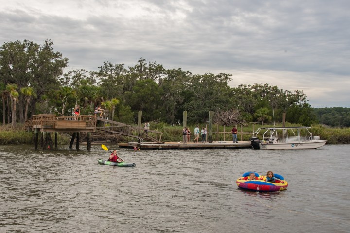 a group of people in a small boat in a body of water