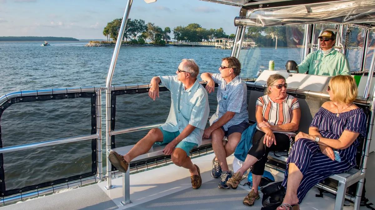 a group of people sitting at a dock